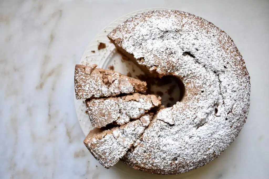 overhead view of chocolate pound cake with a few sliced pieces